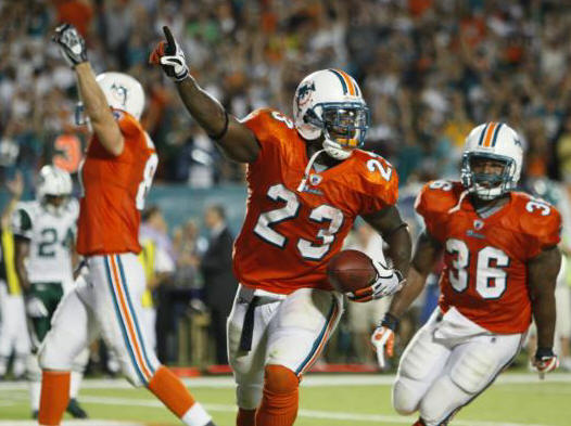 Miami Dolphins RB Ronnie Brown (23) celebrates with TE Joey Haynos, left, and FB Lousaka Polite (36) after Brown scored the winning TD in the 4th quarter against the hated New York Wets on Monday, Oct. 12, 2009, in Miami. The FINS won, 31-27. 